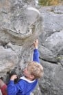Al climbing his first blue problem in Font