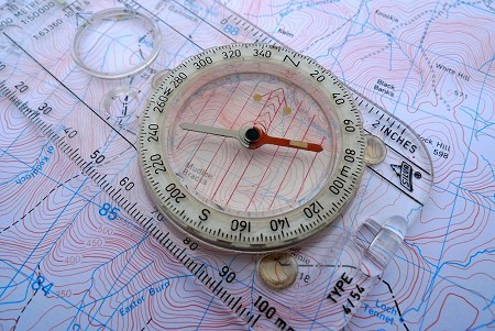 Place the compass on the map so the orienting lines are parallel to the north-south grid lines and the north arrow is pointing to north on the map  © Ian Hey