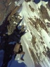 A cheval on a snow arete low on the Innominata route, Mont Blanc