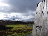 North Wales slate climbing on Solstice (HVS 5a), with the early March snow on the mountains in the background.