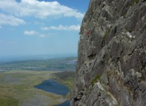 A climber on Outside Edge Route Cwm Silyn