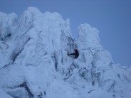 Crux chimney of The Grooved Rib. Paul hunting for gear.