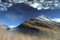 An Sgurr and Luchd Coire reflected trough the broken ice of Loch a'Choire Mor