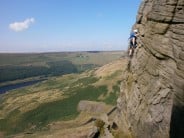 Gary Scott leading swan crack at Dovestones edge. Yeoman hey res. and upperwood quarry in the background