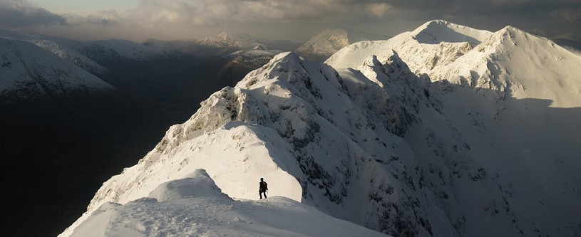 Chris approaching the pinnacles of the Aonach Eagach ridge, in spectacular winter condition.  © Andrew Marshall
