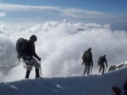 The french army on descent along the exposed snow ridge at the summit