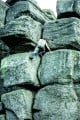 Ken Jackson making a solo ascent of Slippery Crack, Brimham Rocks. 1977.