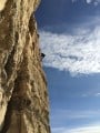 Rachel high above the crux on Downtown Julie Brown, fantastic moves with a perfect sky.