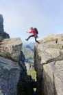 Clay Conlon jumping and praying on the final leap towards the summit of Vågakallen in Lofoten.