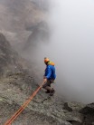 Abseiling into the mist from the summit of Point John in Mt Kenya National park