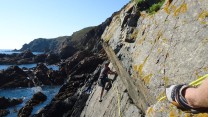 Thomas Falla seconding Wet on Sunset Slab at Le Gouffre, Guernsey