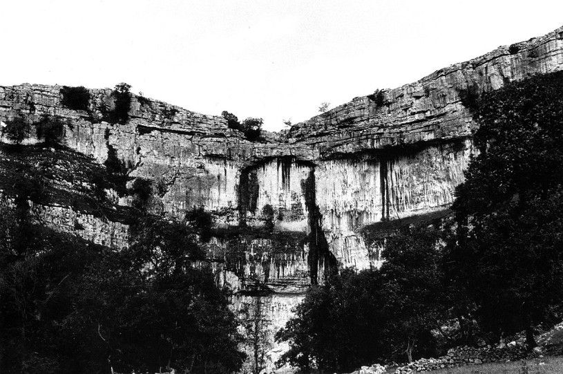 Malham Cove with its central wall, almost 300ft high, visible. In 1984 this was the biggest piece of rock in the The Pennines without a single free route on it, except at its extreme left-hand end. Photo Ian Smith.  © Ian Smith