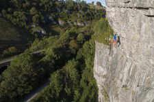Tom Randall cutting loose on The Spider (8a) on Plum Buttress in Chee Dale