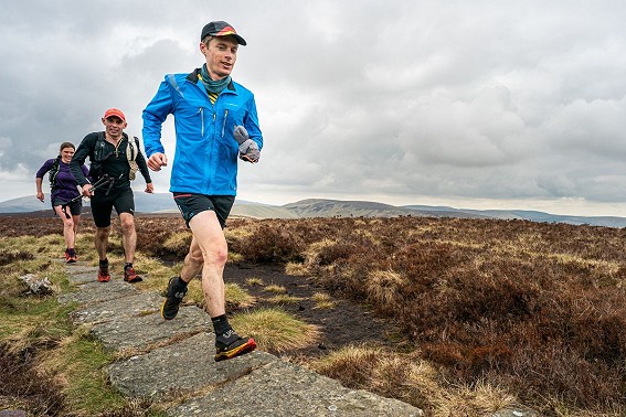 John Kelly and some very capable support runners on one of the flagstone-paved sections of the Pennine Way  © Steve Ashworth