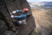 Willis Morris pulling through the final roof of Overhanging Crack on The Cioch