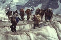 Balti porters making their way up the Biafo glacier, Pakistan, 1992.