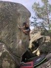 Flo Tilley grappling with insecure feet and not enough handholds on the classic arête of Rababoum, 7A, Fontainebleau