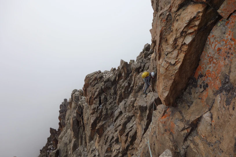 Nikki on the traverse high up on Neilion. It's easier than it looks but still a little gnarly.  © Tom Ripley
