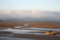 Sun setting over Duddon Estuary with Scafell and The Old Man of Coniston in the background